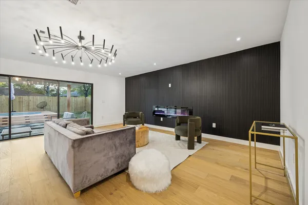 a living room with furniture and a chandelier