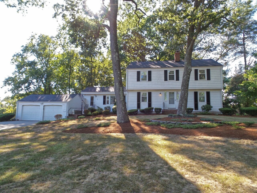 33 James Road Reading, MA 01867 - Photo 1 of 27 a front view of a house with a yard and large trees