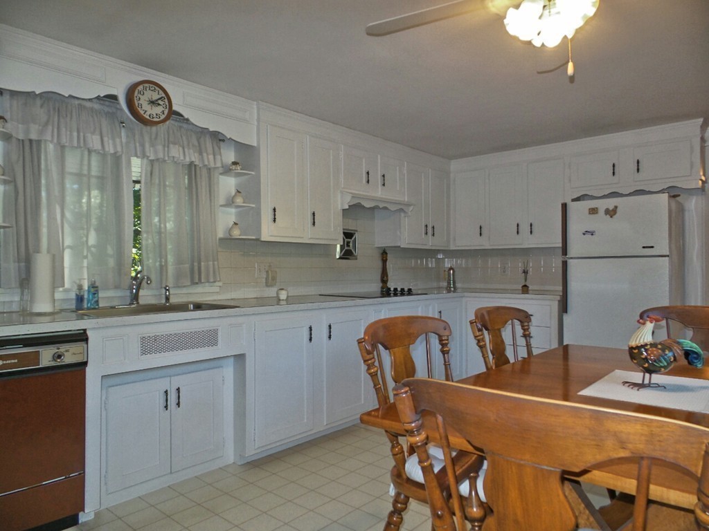 33 James Road Reading, MA 01867 - Photo 11 of 27 a view of kitchen with sink table and chairs