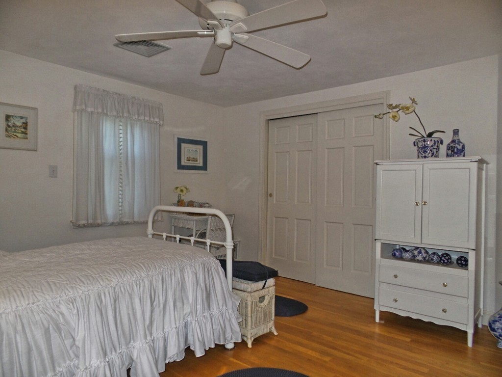 33 James Road Reading, MA 01867 - Photo 13 of 27 a bedroom with a bed and wooden floor