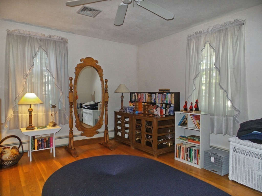 33 James Road Reading, MA 01867 - Photo 16 of 27 a bedroom with bed and a chandelier