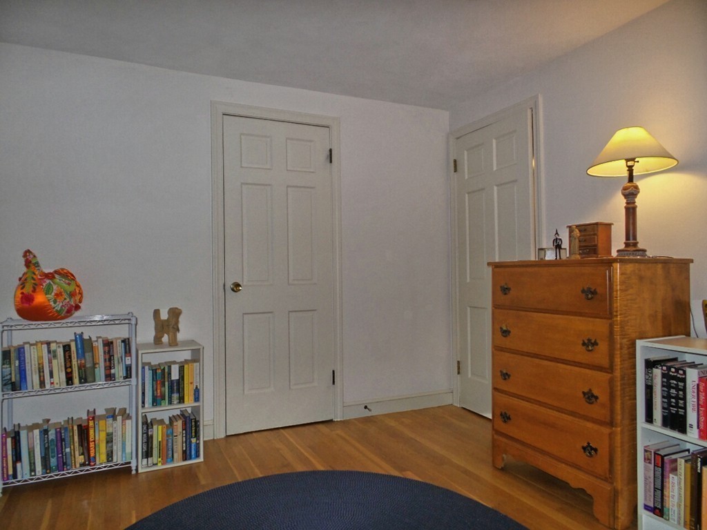 33 James Road Reading, MA 01867 - Photo 17 of 27 a bedroom with a bed and a bookshelf