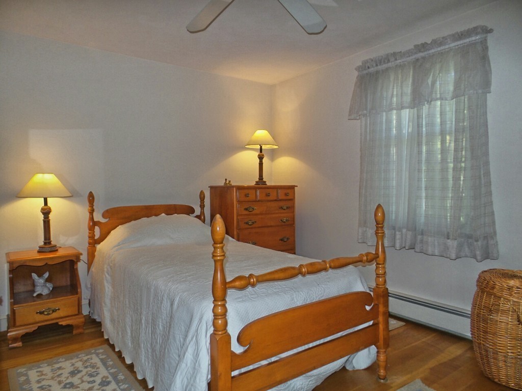 33 James Road Reading, MA 01867 - Photo 20 of 27 a bedroom with a bed and a lamp on table