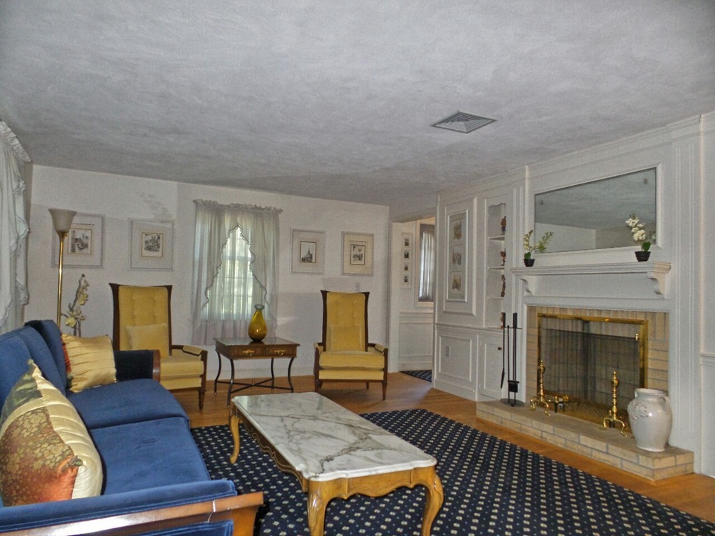 33 James Road Reading, MA 01867 - Photo 3 of 27 a living room with furniture and a fireplace