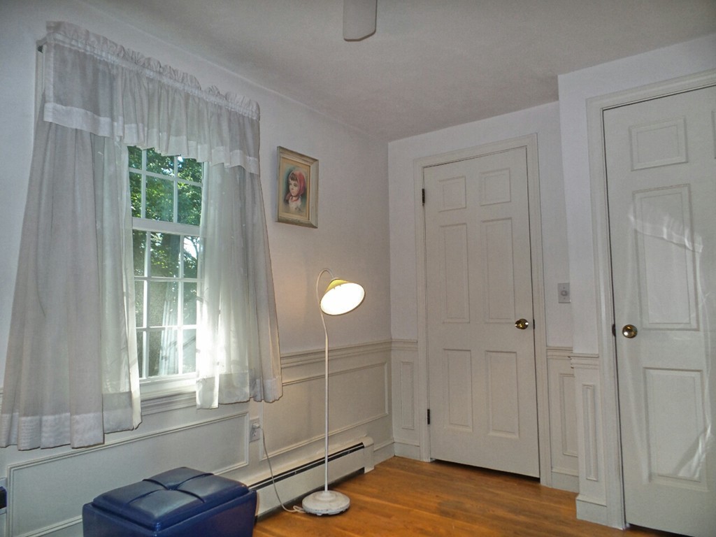 33 James Road Reading, MA 01867 - Photo 7 of 27 a view of an empty room with wooden floor and windows