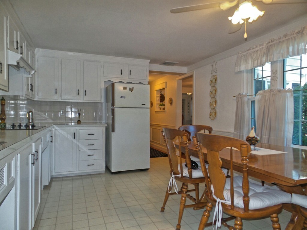 33 James Road Reading, MA 01867 - Photo 8 of 27 a kitchen with refrigerator and cabinets