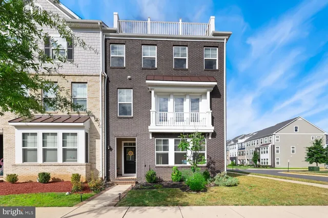 front view of a brick house with a yard