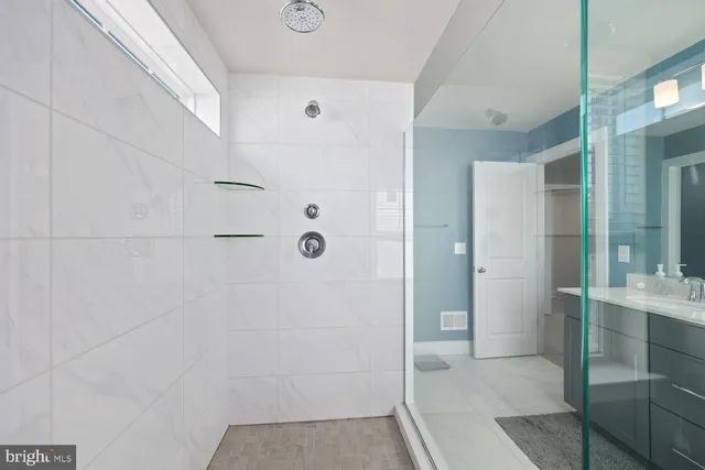 a bathroom with a shower and a sink