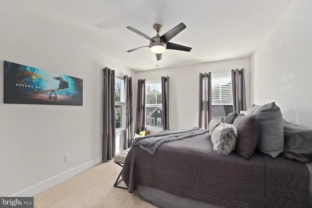 a large bedroom with a large bed and a chandelier