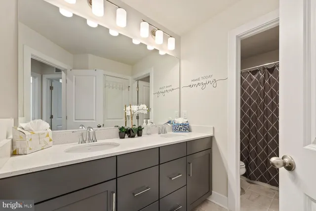 a bathroom with double vanity sink and a mirror
