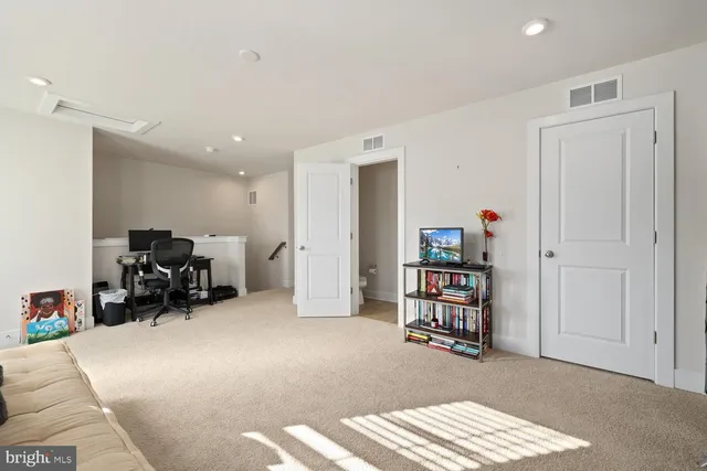 a bed room with a bed and a chair