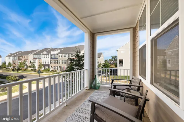 a balcony with furniture and wooden floor