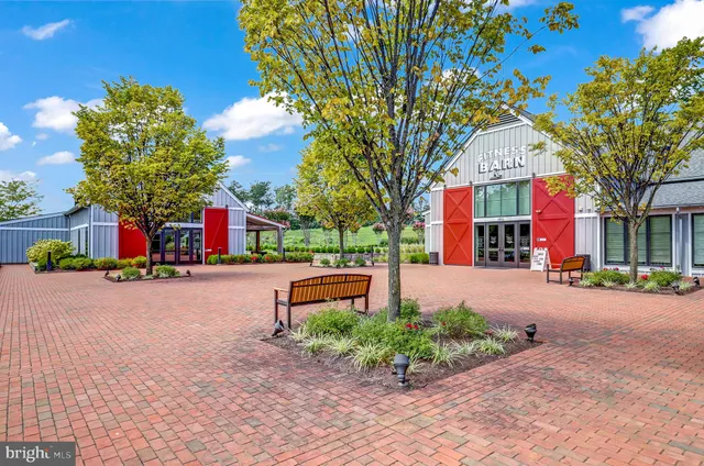a view of a patio with dining table and chairs with a garden
