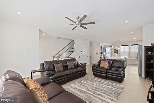 a living room with furniture and kitchen view