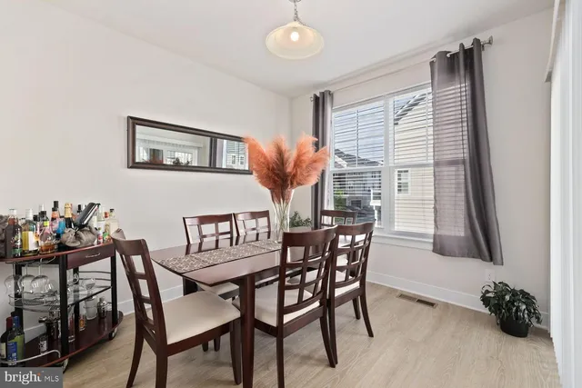 a view of a dining room with furniture and a window