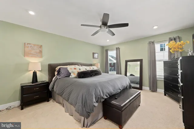 a bedroom with a bed and ceiling fan
