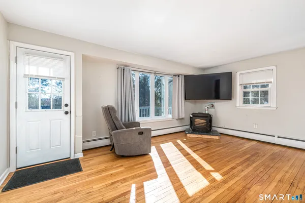 a living room with furniture fireplace and flat screen tv