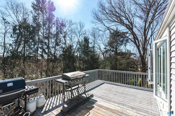 a view of balcony with wooden floor and outdoor seating