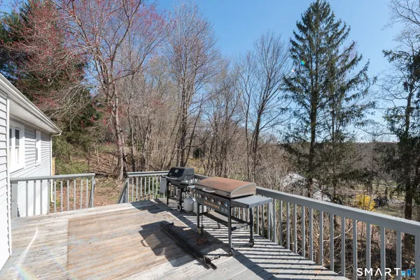a view of a balcony with wooden floor and fence