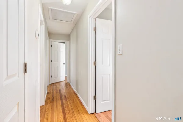 a view of a hallway with wooden floor