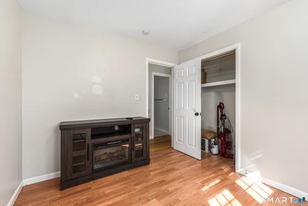 a view of bedroom with furniture and wooden floor