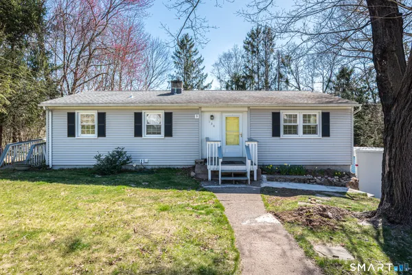 a view of a house with patio and a yard