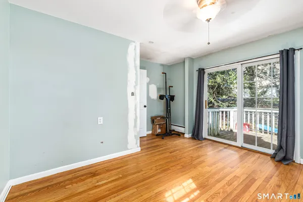 a view of a room with wooden floor and a balcony