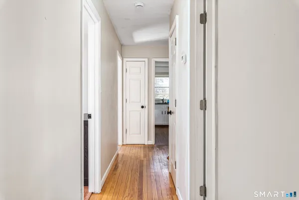 a view of a hallway with wooden floor