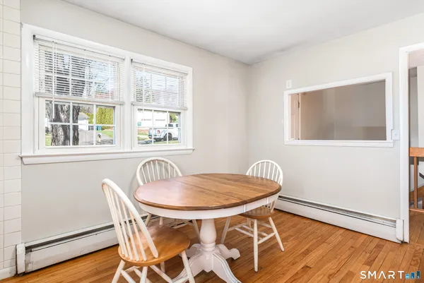 a dining room with furniture and window