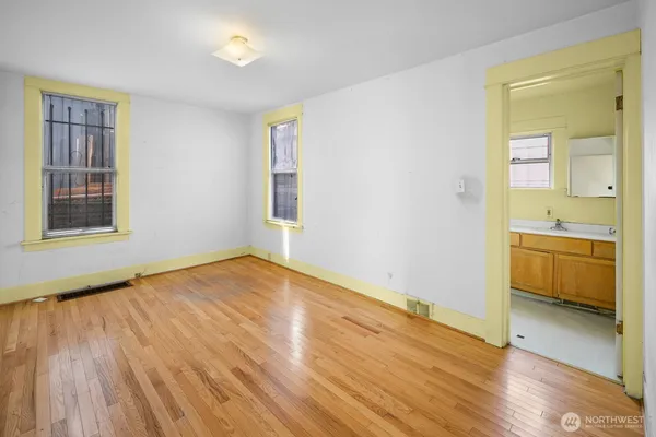 a view of a room with wooden floor and a window