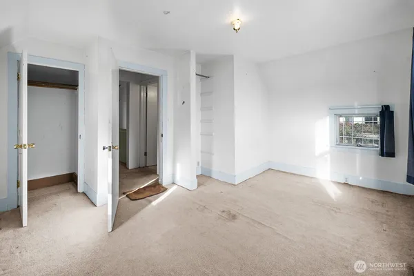 an empty room with windows and entrance