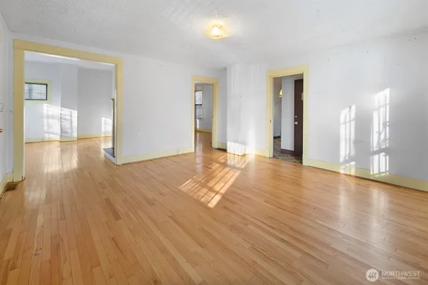 a view of a room with wooden floor and a window