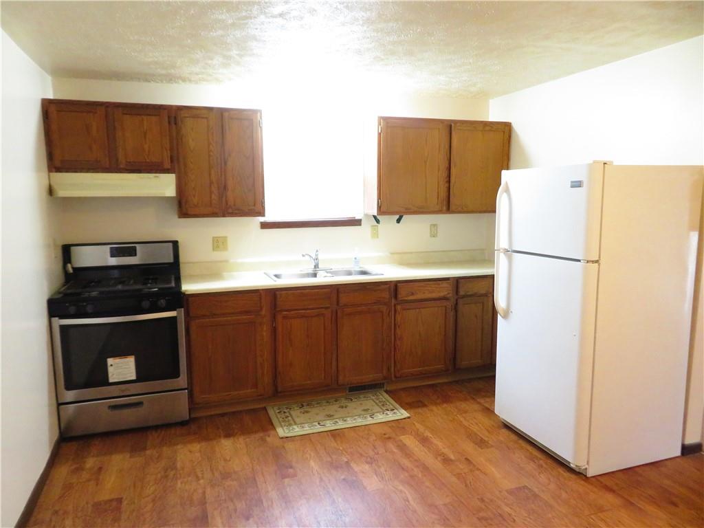 333 West Brady Street Butler, PA 16001 - Photo 5 of 9 a kitchen with a sink a stove and a refrigerator