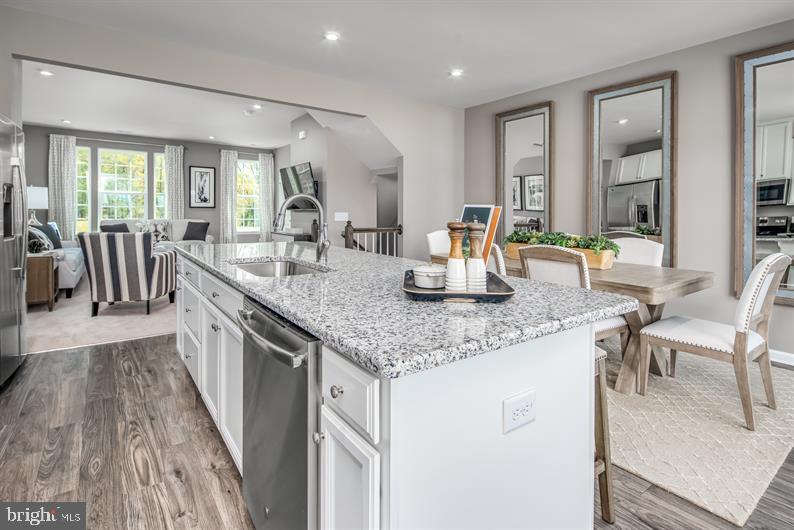 7911 Mine Run Road Hanover, MD 21076 - Photo 4 of 27 a dining hall with stainless steel appliances granite countertop a stove and a sink