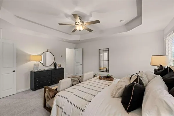 a bedroom with furniture and a chandelier