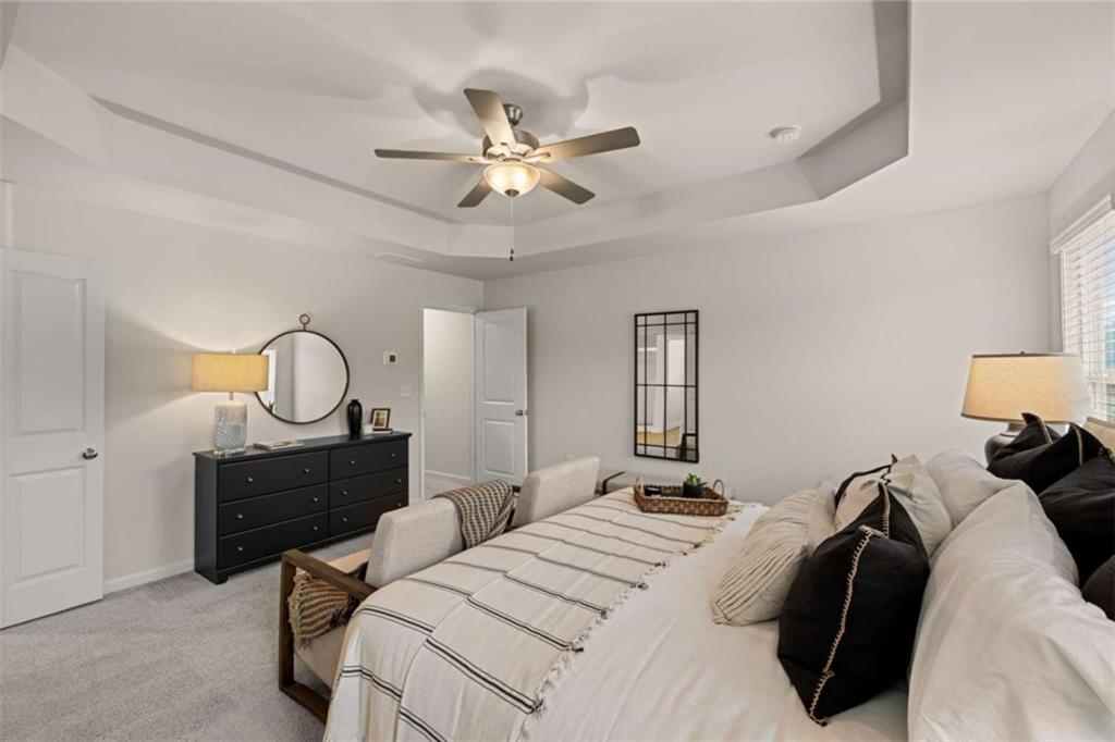 1047 Merritt Drive, Unit 88 Villa Rica, GA 30180 - Photo 29 of 47 a bedroom with a bed window and a chandelier