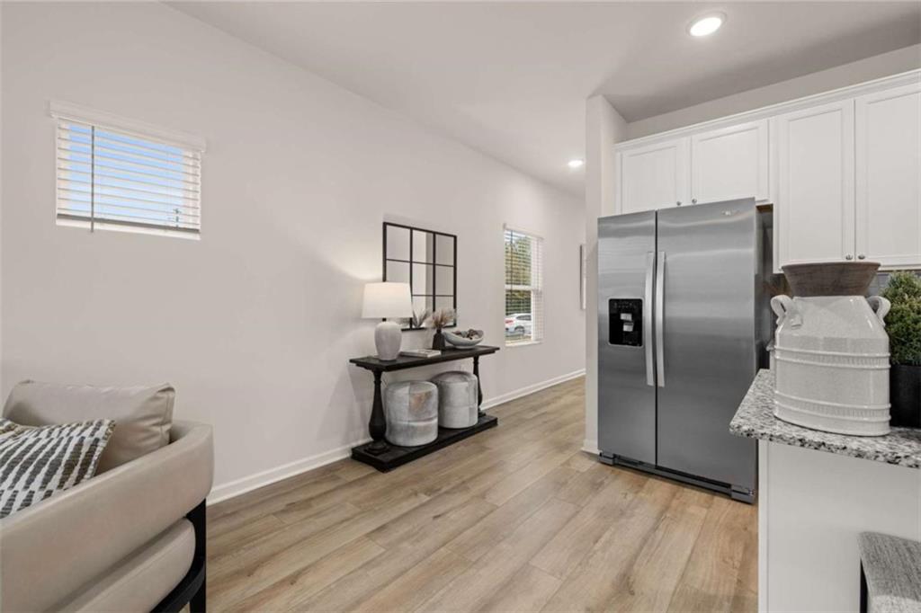 1047 Merritt Drive, Unit 88 Villa Rica, GA 30180 - Photo 41 of 47 a kitchen with stainless steel appliances wooden floor and a refrigerator