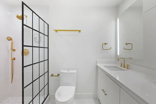 a bathroom with a toilet sink shower and mirror