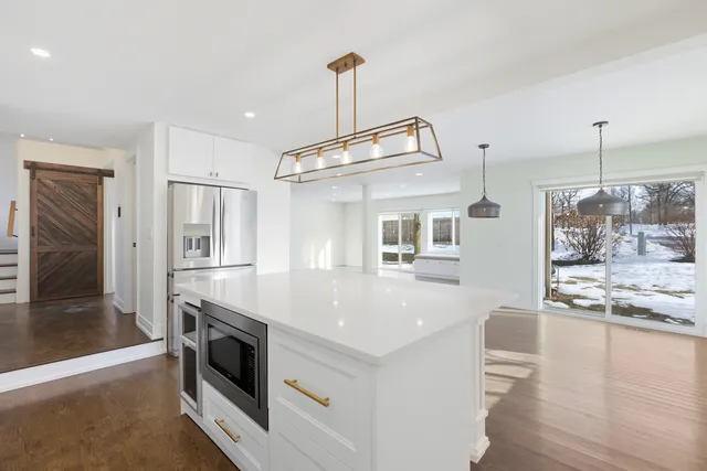 a kitchen with a stove a refrigerator and a fireplace