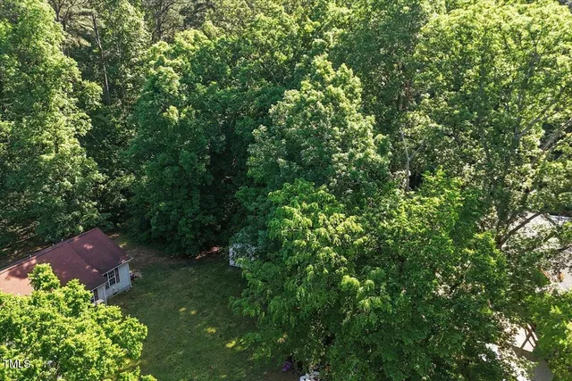 an aerial view of a house with yard