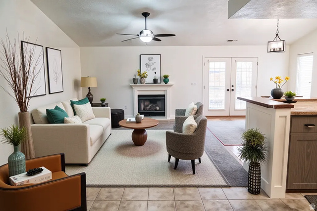 1825 West Mathis Park Place, Unit 40 St. George, UT 84770 - Photo 7 of 28 Living room featuring french doors, a ceiling fan, a glass covered fireplace, light tile patterned floors, and lofted ceiling
