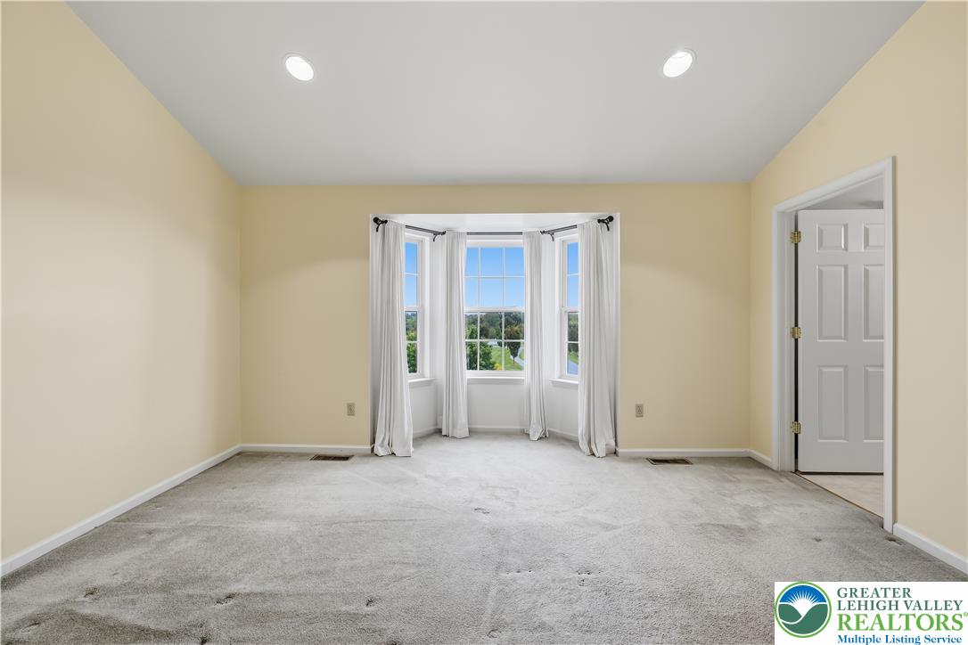 5607 Spring Ridge Drive West Macungie, PA 18062 - Photo 17 of 26 An elegant bay window frames peaceful green views in this spacious, carpeted room.