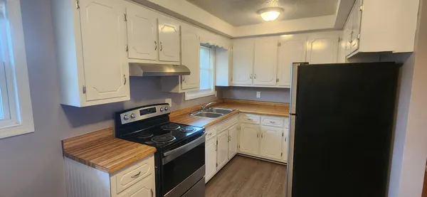 a kitchen with a stove and a refrigerator