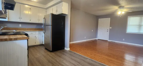 a kitchen with a refrigerator and a stove top oven