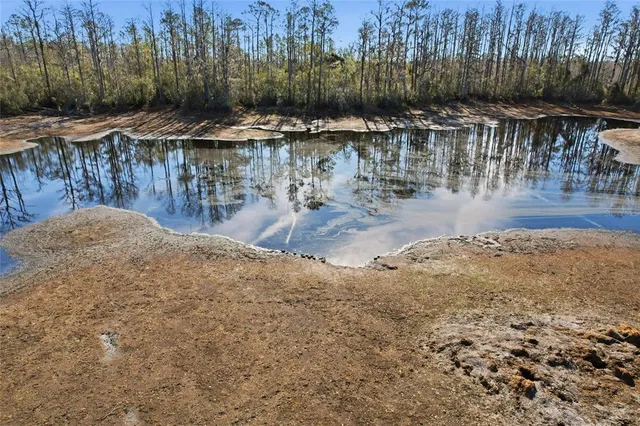 a red brick house with trees in front of it