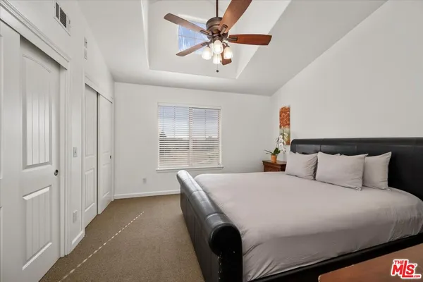 a bedroom with a large bed and a large window