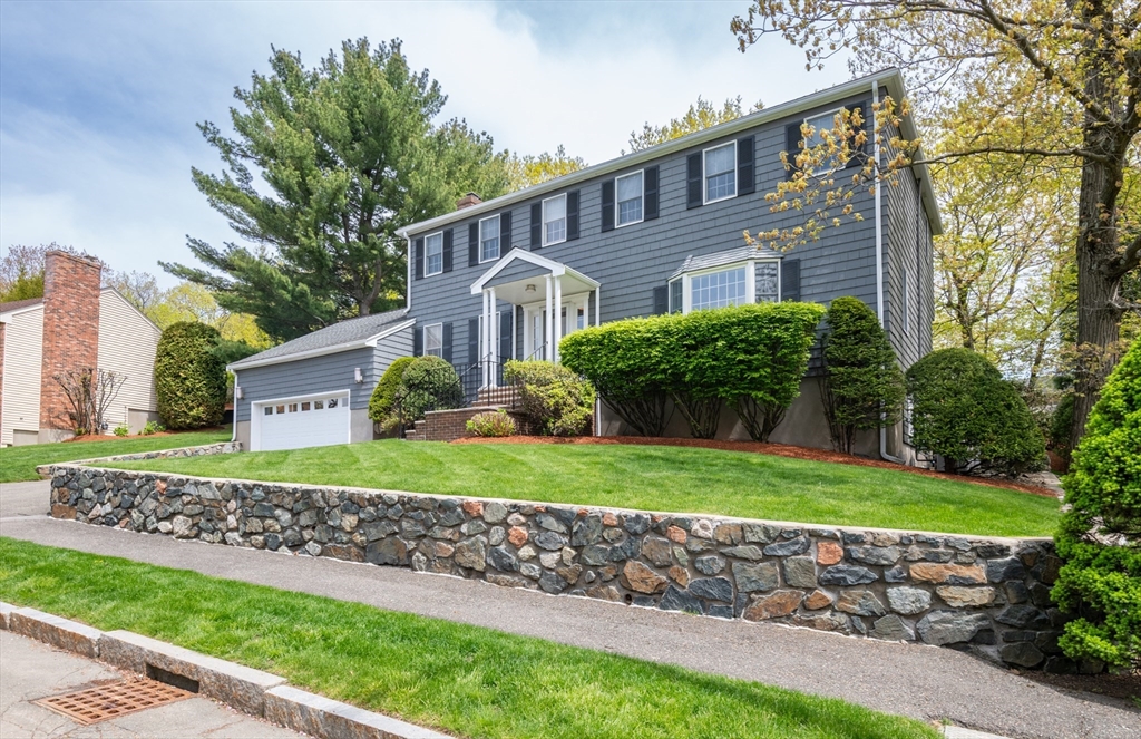 25 Ellen Road Stoneham, MA 02180 - Photo 3 of 41 a front view of a house with a yard and potted plants