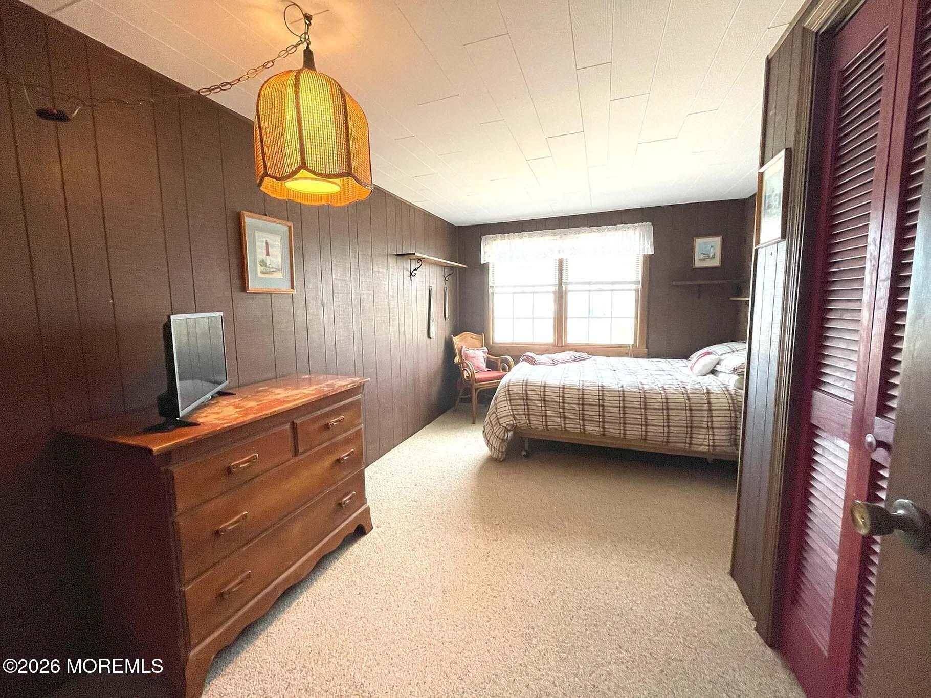 207 Bay Boulevard Lavallette, NJ 08735 - Photo 12 of 62 a bedroom with a bed and a chandelier