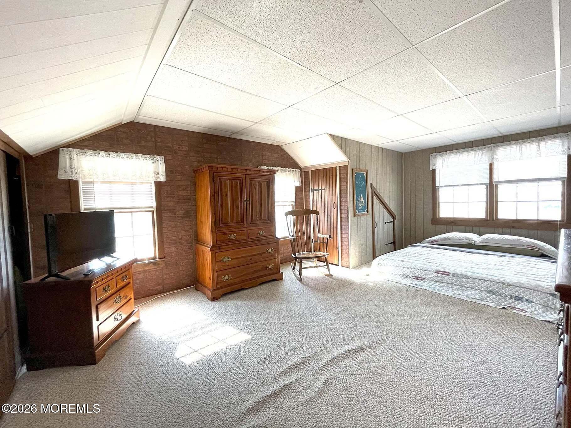 207 Bay Boulevard Lavallette, NJ 08735 - Photo 15 of 62 a spacious bedroom with a bed and a flat screen tv