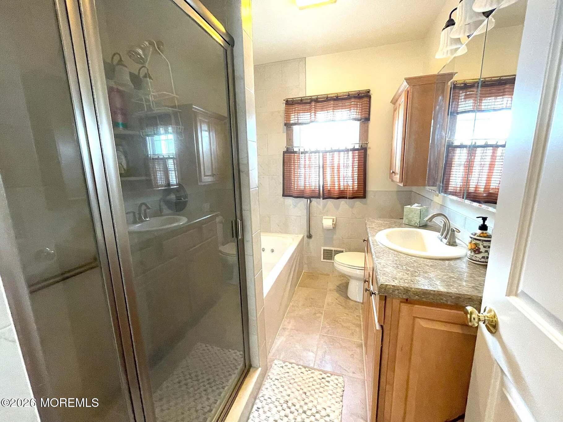 207 Bay Boulevard Lavallette, NJ 08735 - Photo 20 of 62 a bathroom with a granite countertop sink and a mirror